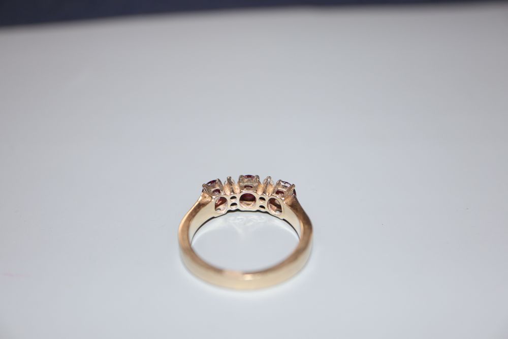 A modern 18ct, ruby and diamond set dress ring, size M, gross 5.6 grams.